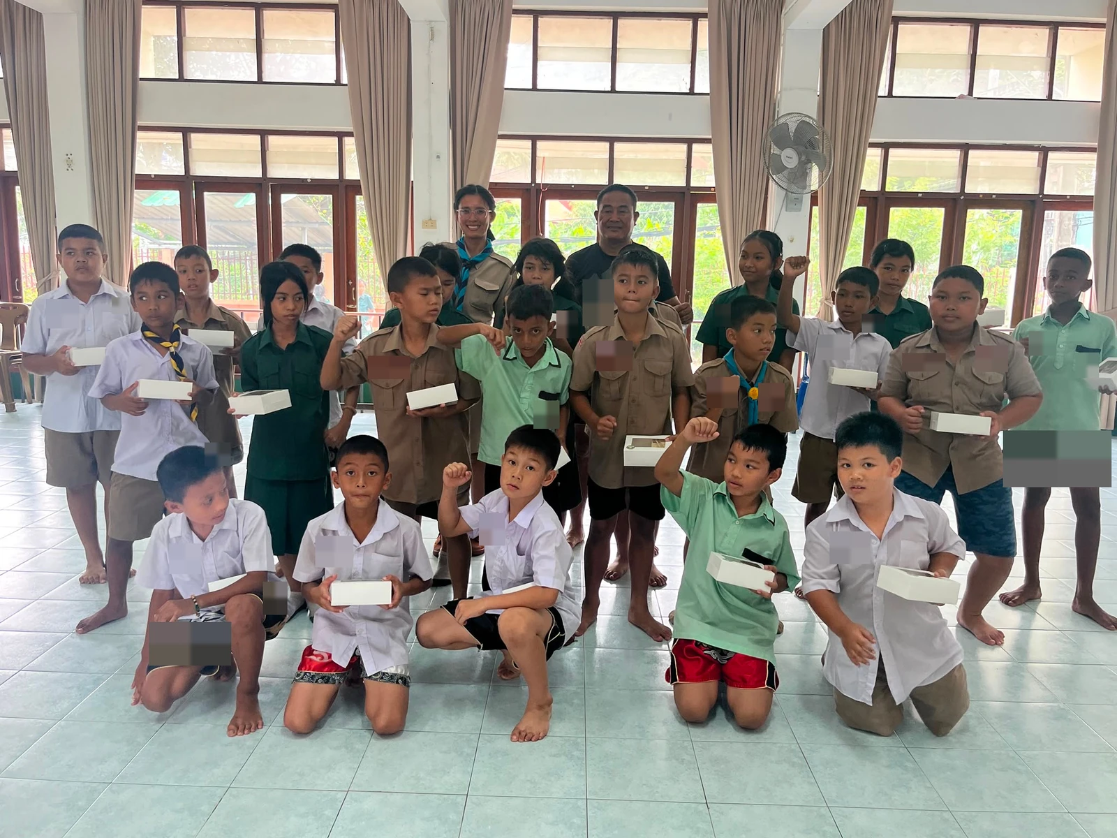 Young people holding food boxes during a group activity.